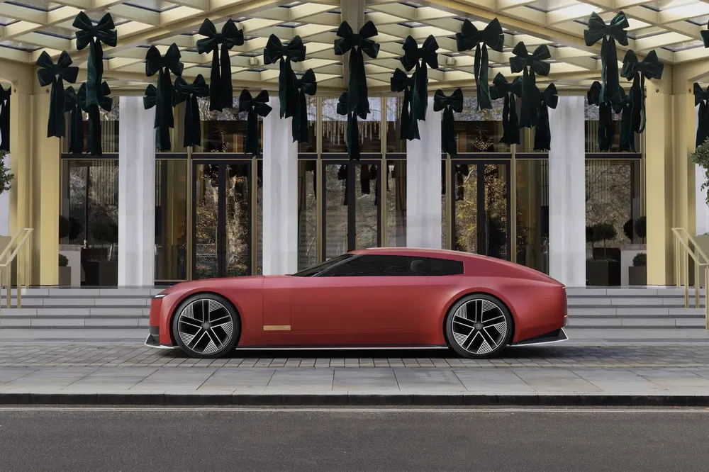 {"fr":"Concept car électrique rouge garé devant un bâtiment moderne avec des rubans noirs décoratifs.","nl":"Rode elektrische conceptauto geparkeerd voor modern gebouw met zwarte decoratieve linten."}