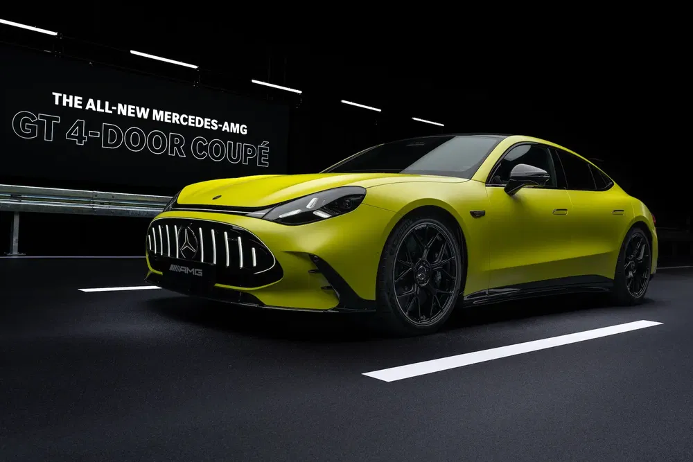 Nouvelle Mercedes-AMG GT 4-Door Coupé jaune vif sur fond sombre élégant.