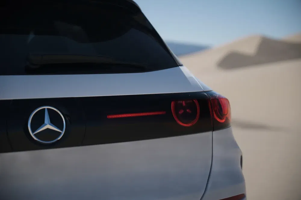 Vue arrière d'une voiture Mercedes-Benz moderne dans un désert, avec des phares élégants.