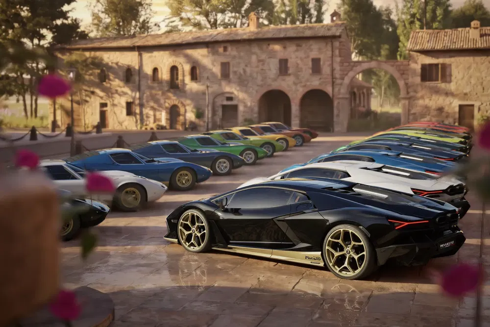 Lamborghini Lanzador noir devant une rangée de sportives colorées dans un domaine rustique.