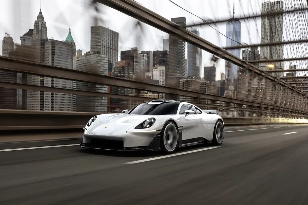 Witte Porsche rijdt over een stedelijke brug met skyline op de achtergrond.