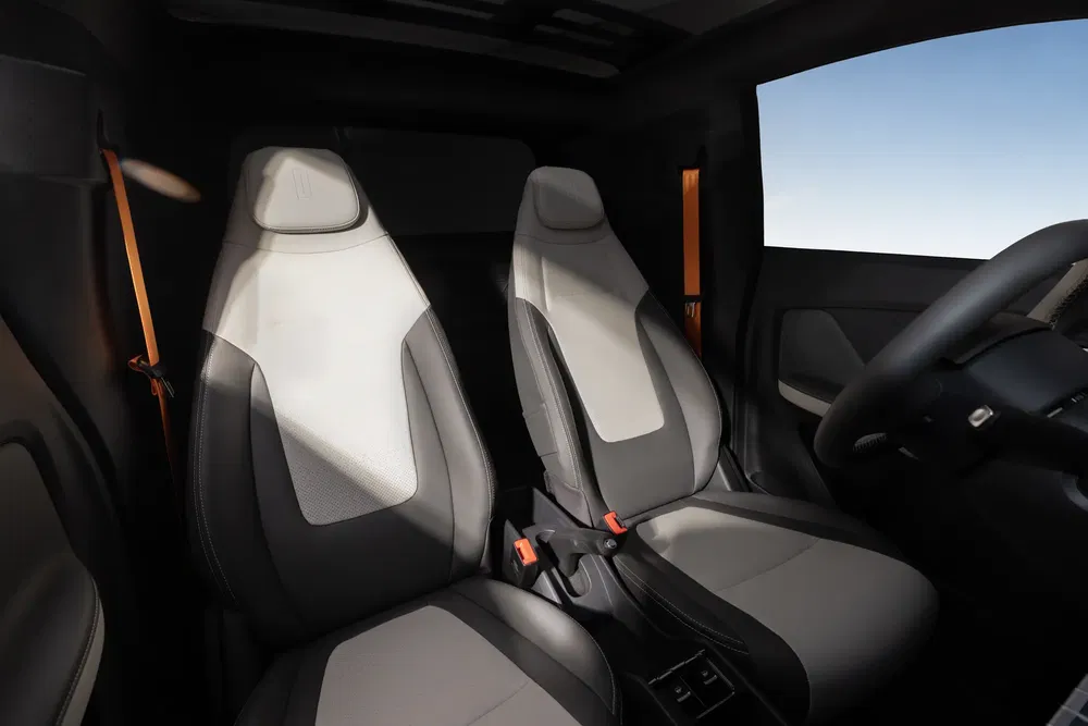 Intérieur d'une voiture compacte avec sièges avant modernes et volant visible.