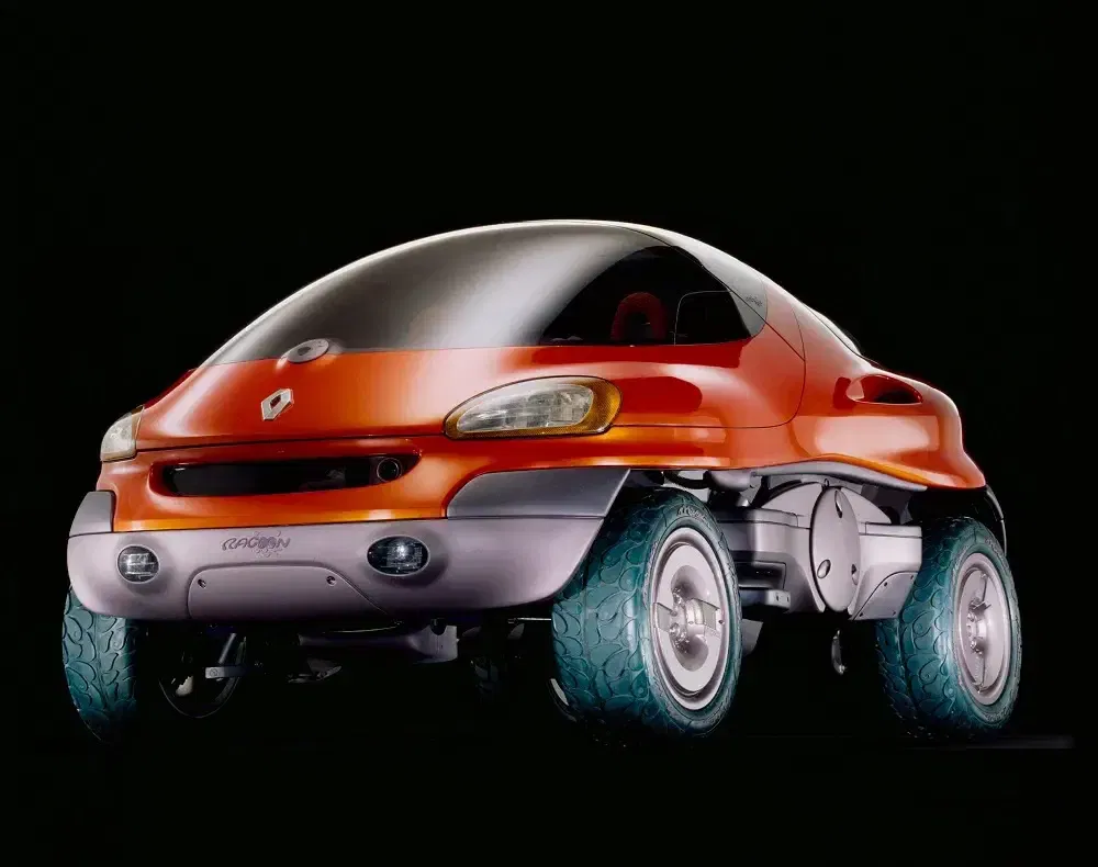 {"fr":"Concept car Renault Racoon rouge futuriste avec roues tout-terrain distinctives, design innovant.","nl":"Futuristische rode Renault Racoon conceptauto met opvallende terreinbanden, innovatief ontwerp."}