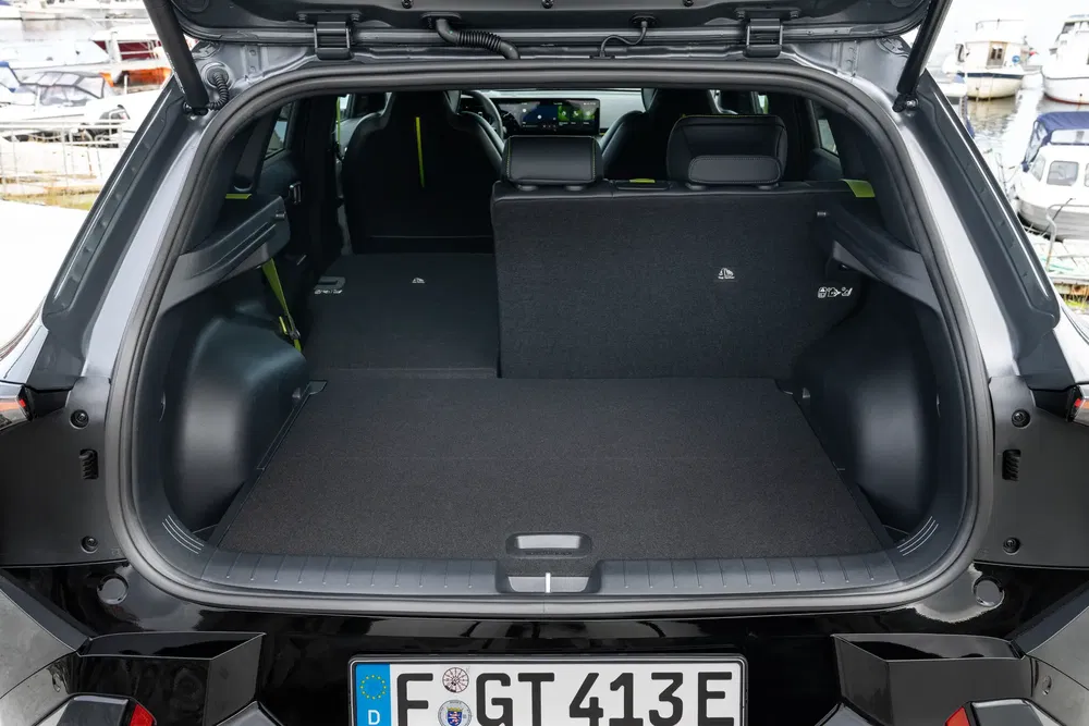 Coffre spacieux d'une voiture électrique avec banquette arrière rabattable.