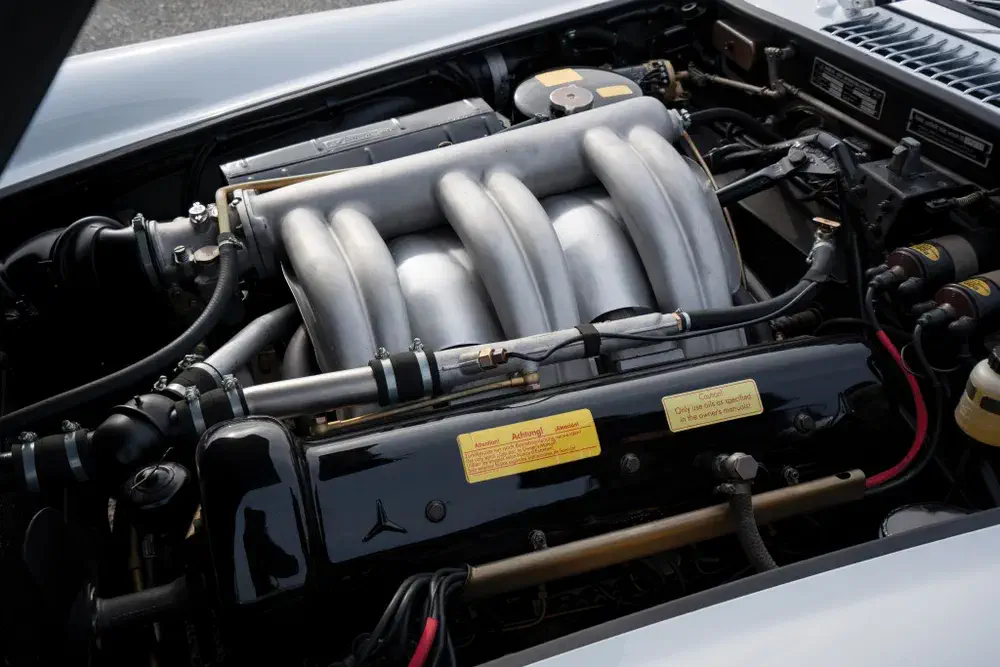 Moteur Mercedes-Benz avec collecteurs d'admission distinctifs dans un compartiment moteur propre.