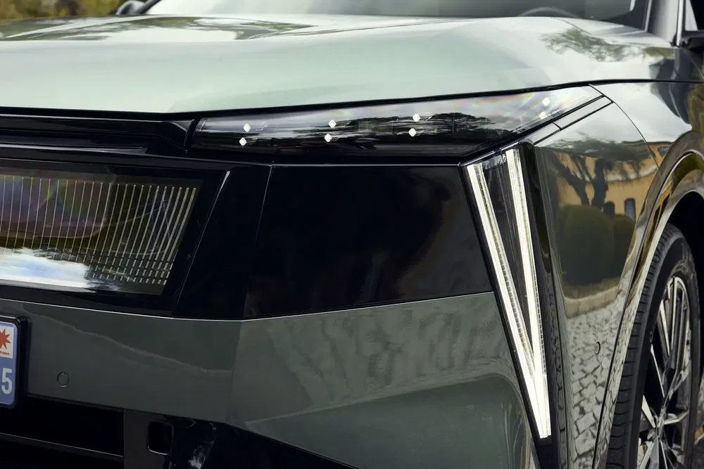 Voorste koplamp van een moderne elektrische SUV met hoekig ontwerp en opvallende LED-verlichting.