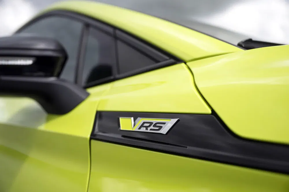 Close-up van een Škoda-auto met VRS-logo op felgele carrosserie.