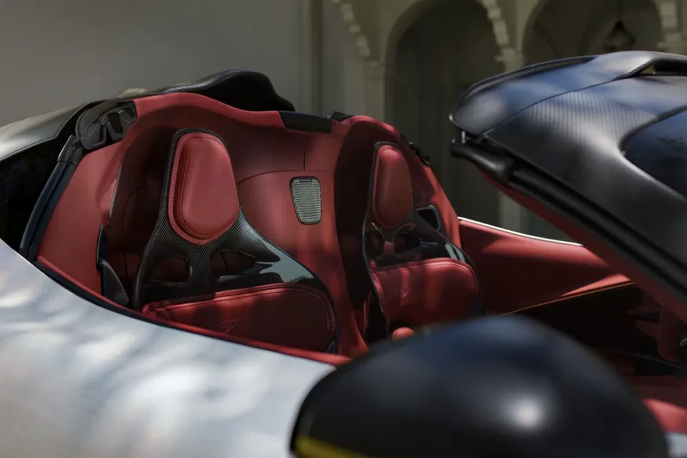 Intérieur d'une supercar avec sièges sport en cuir rouge et fibre de carbone.