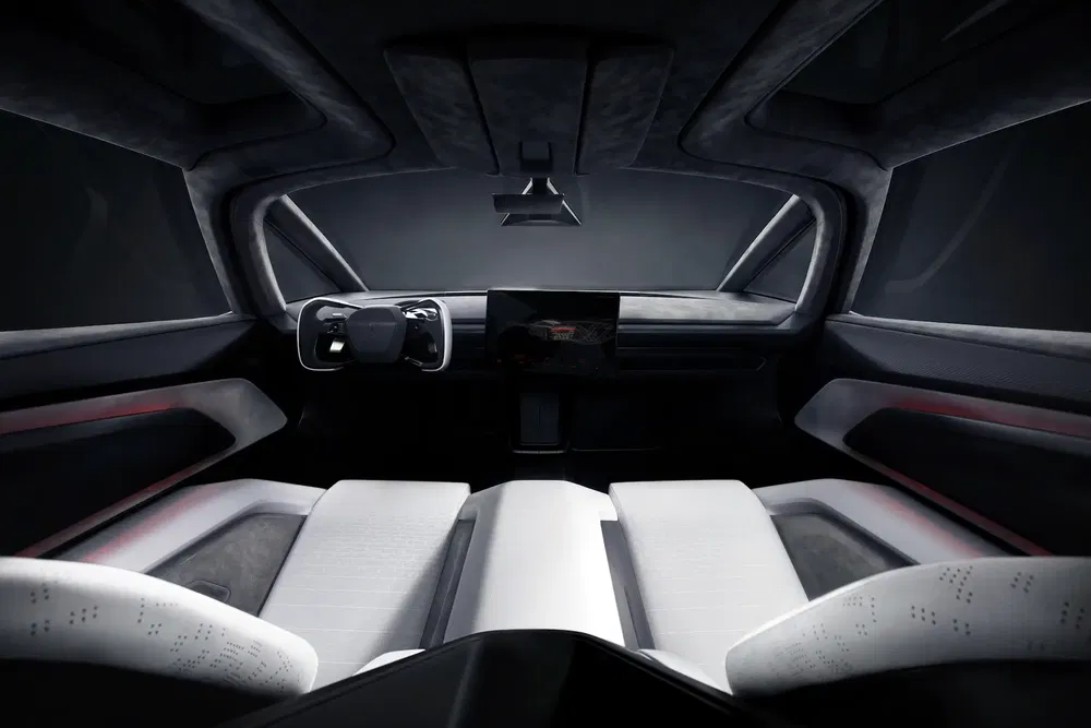 Intérieur futuriste de voiture électrique, écran tactile central, volant innovant.