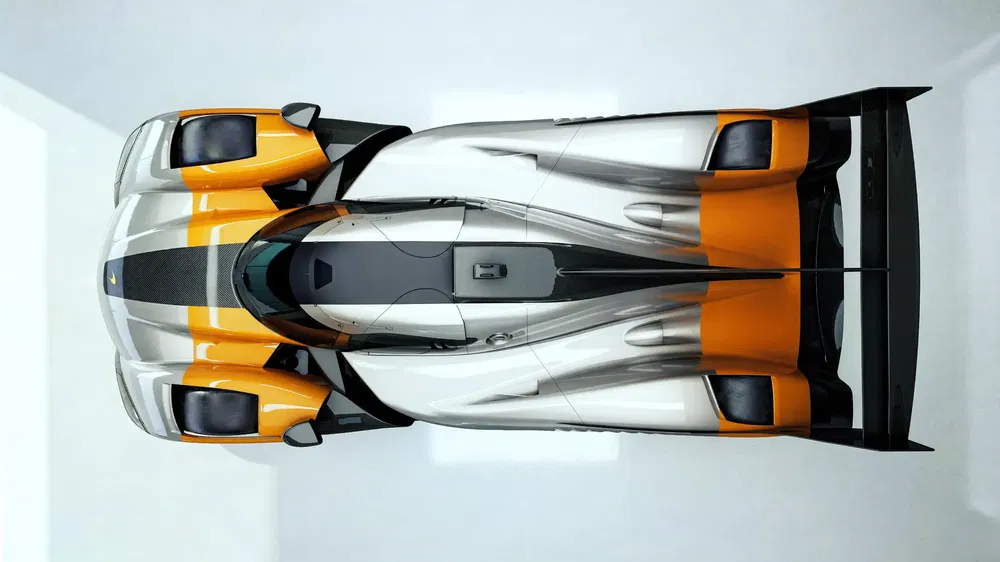 Vue aérienne d'une Porsche 911 GT1 moderne, design aérodynamique et couleurs contrastées.
