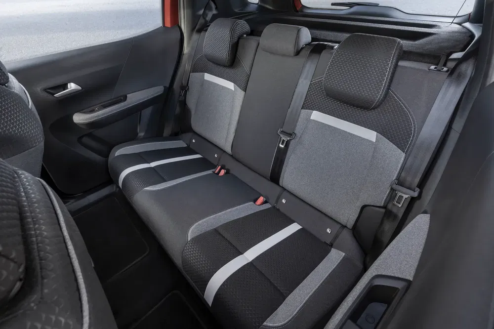 Banquette arrière spacieuse et moderne d'une voiture compacte avec finitions bicolores.