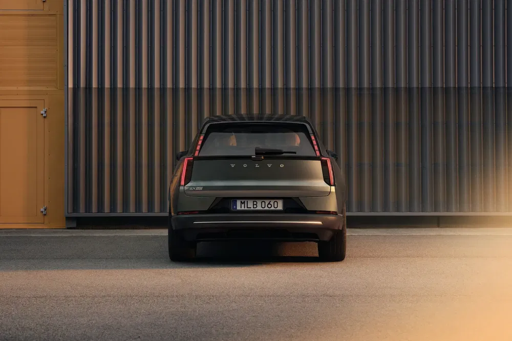 Vue arrière de la Volvo avec design moderne contre une façade industrielle.