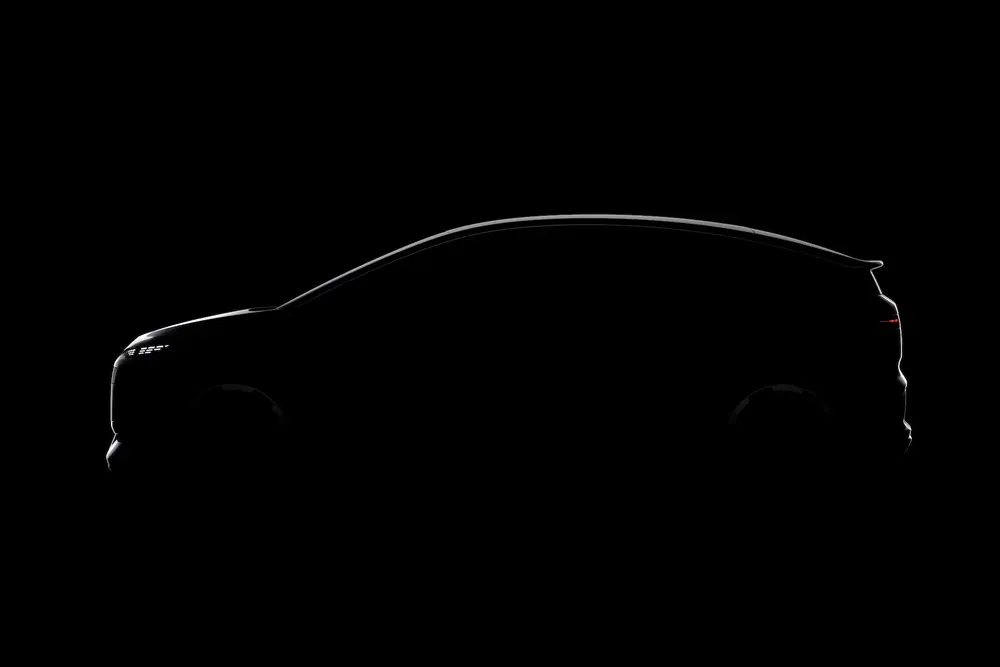 Silhouette de voiture électrique moderne sur fond noir, design aérodynamique élégant.