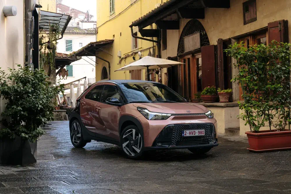 Toyota Aygo X geparkeerd in een smalle steeg van het historische stadscentrum.