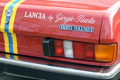 Détail arrière d'une Lancia Trevi Volumex rouge avec marquage Giorgio Pianta distinctif.