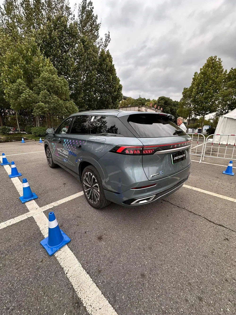 Grijze JAECOO 7 SUV buiten met blauwe verkeerskegels.