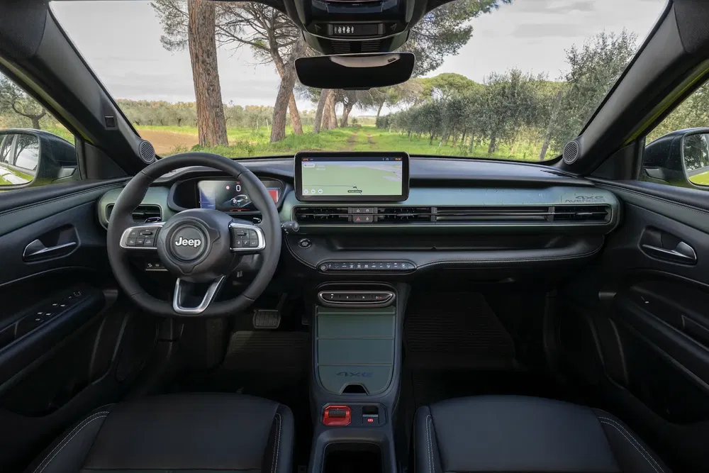 Intérieur moderne du Jeep Avenger, écran central et volant multifonction noir.