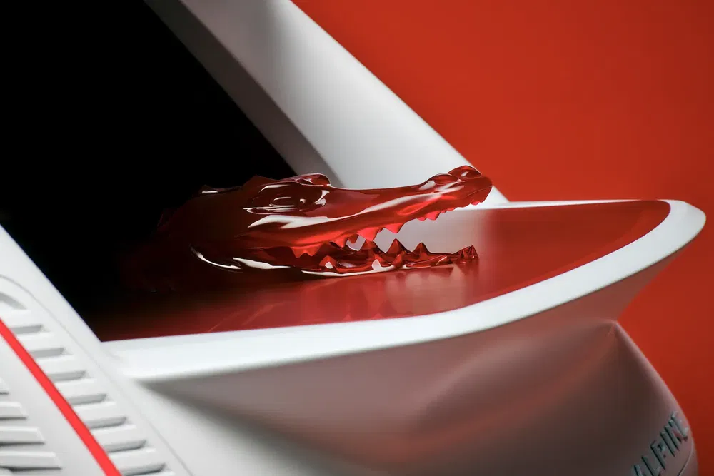 Concept car Alpine avec détail d'un alligator rouge en matériau transparent sur l'aile.