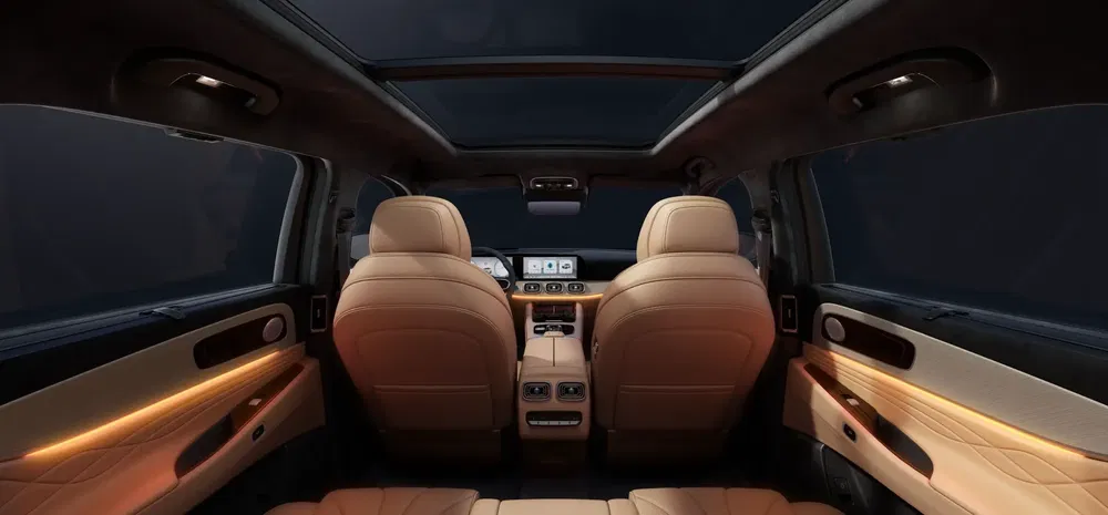 Luxe interieur met beige lederen stoelen en panoramisch dak van een moderne SUV.