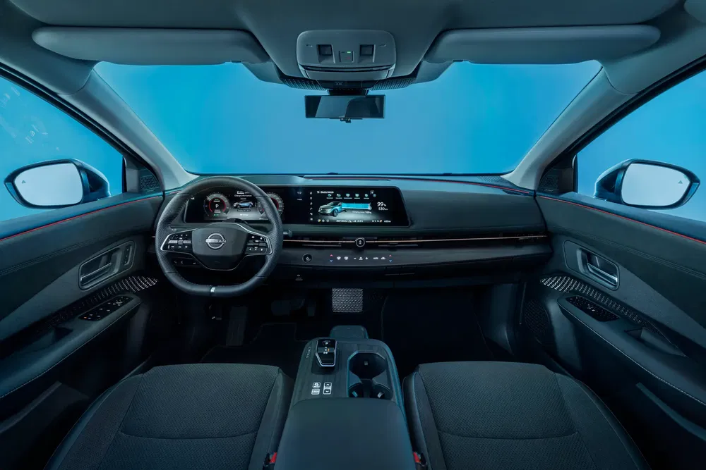 Intérieur moderne d'une Nissan avec tableau de bord numérique et écran tactile.