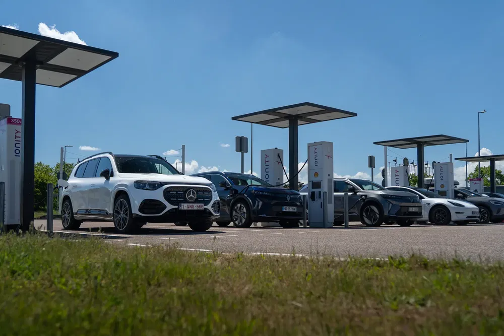 Voitures électriques Mercedes-Benz chargées à une station Ionity sous un ciel bleu clair.