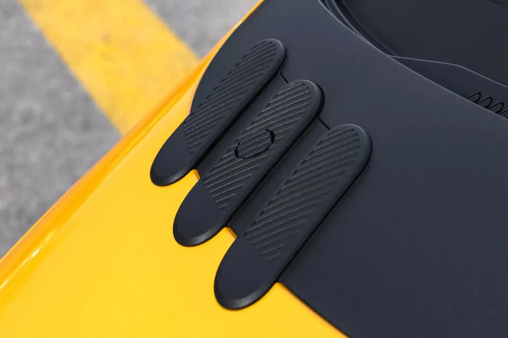 Gros plan sur le capot d'une Chevrolet Corvette C8 Z06 jaune avec attaches aérodynamiques.