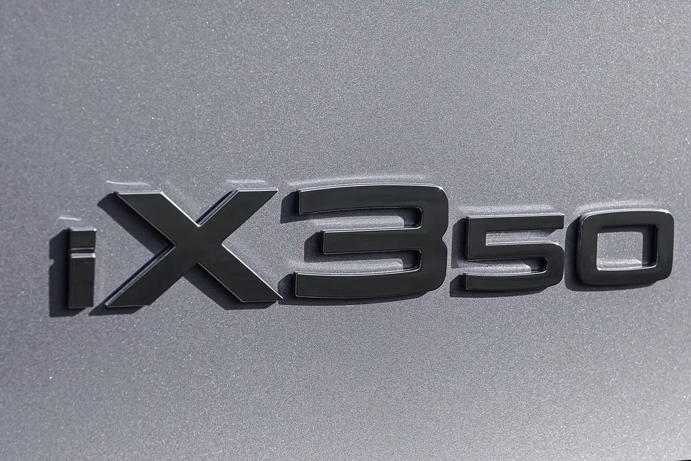 Insigne BMW iX3 50 sur une carrosserie gris métallisé.