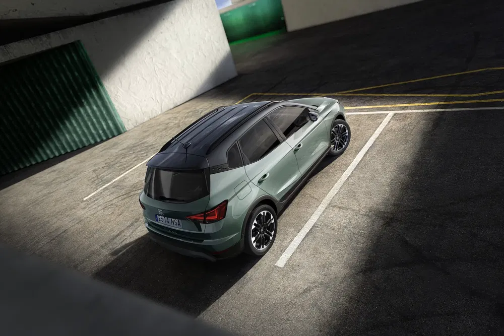 SUV vert Skoda dans un parking ombragé, vue arrière, design moderne et élégant.
