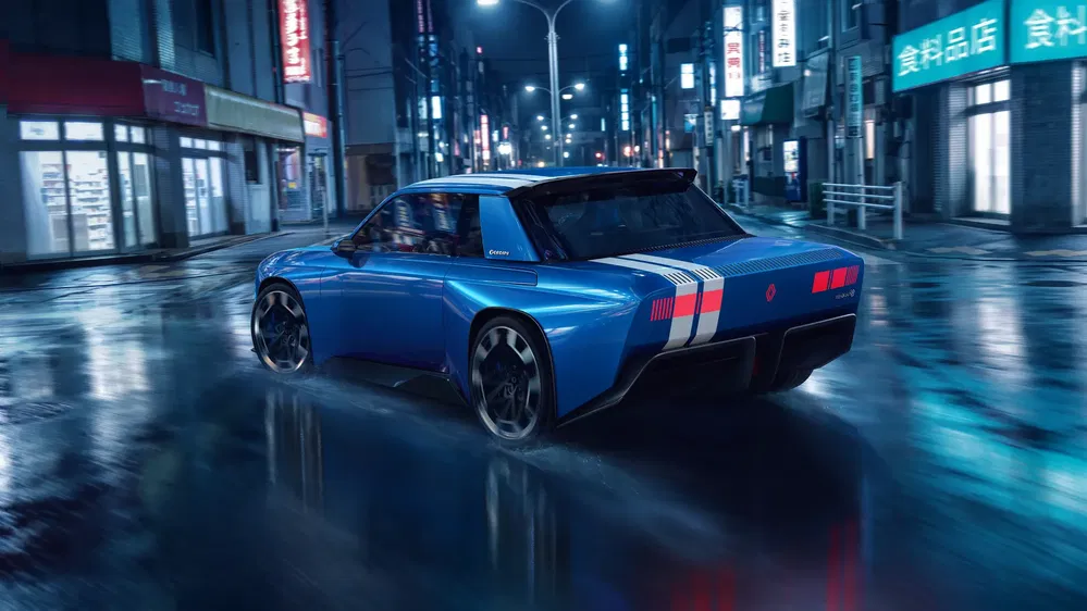 Concept car électrique Renault bleu sur rue de nuit, style futuriste et rétro.