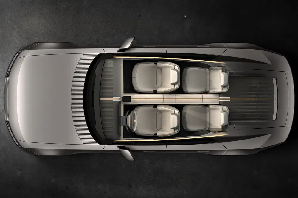 Bovenaanzicht van een moderne conceptauto-interieur met vier aparte witte lederen stoelen.
