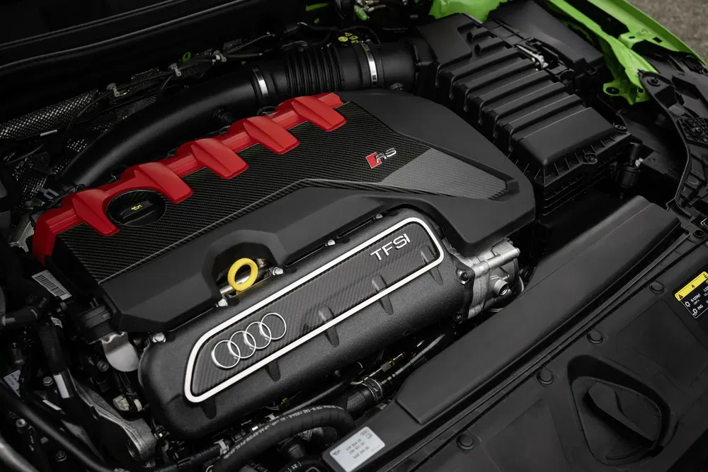 Audi RS TFSI motor met rode accenten en koolstofvezel behuizing voor hoge prestaties.