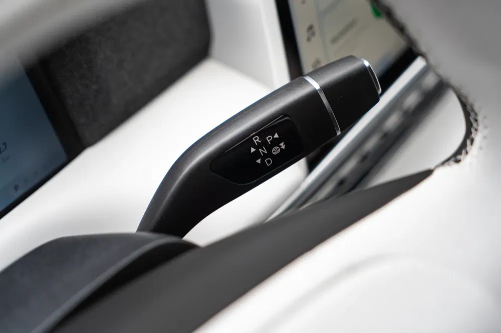 Levier de changement de vitesse Tesla dans un véhicule électrique intérieur moderne.