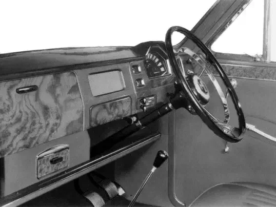 Intérieur vintage d'une voiture Humber avec tableau de bord en bois et volant classique.