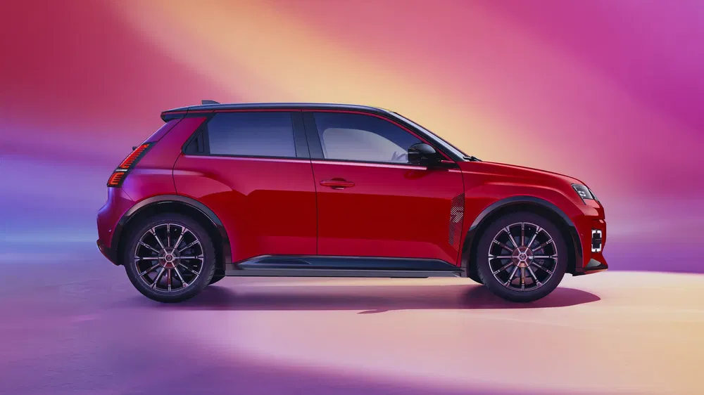 Renault 5 rouge sur fond coloré, design moderne et compact.