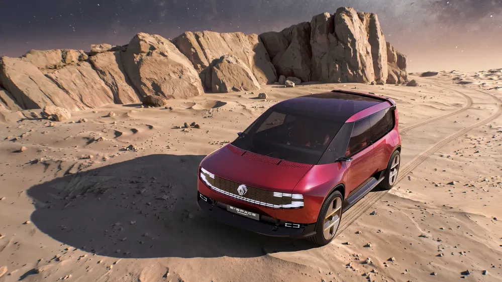Concept car Renault sur terrain désertique, design futuriste et allure robuste.