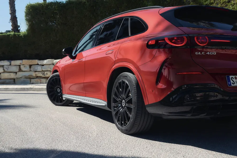 Rode Mercedes-Benz GLC 400 met zwarte velgen, moderne SUV geparkeerd op straat.