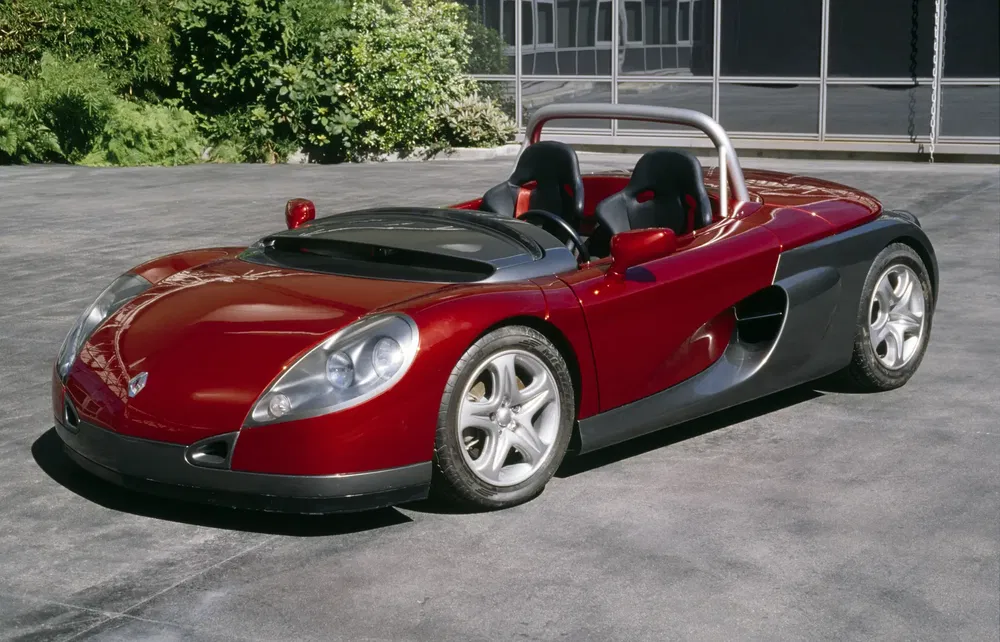 {"fr":"Renault Sport Spider rouge décapotable sur chaussée, conçu pour performance et sportivité.","nl":"Rode Renault Sport Spider cabrio op bestrating, ontworpen voor prestaties en sportiviteit."}