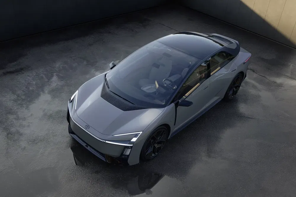 Moderne Hyundai Ioniq 6 elektrische wagen, gestroomlijnd ontwerp, geparkeerd in industriële omgeving.