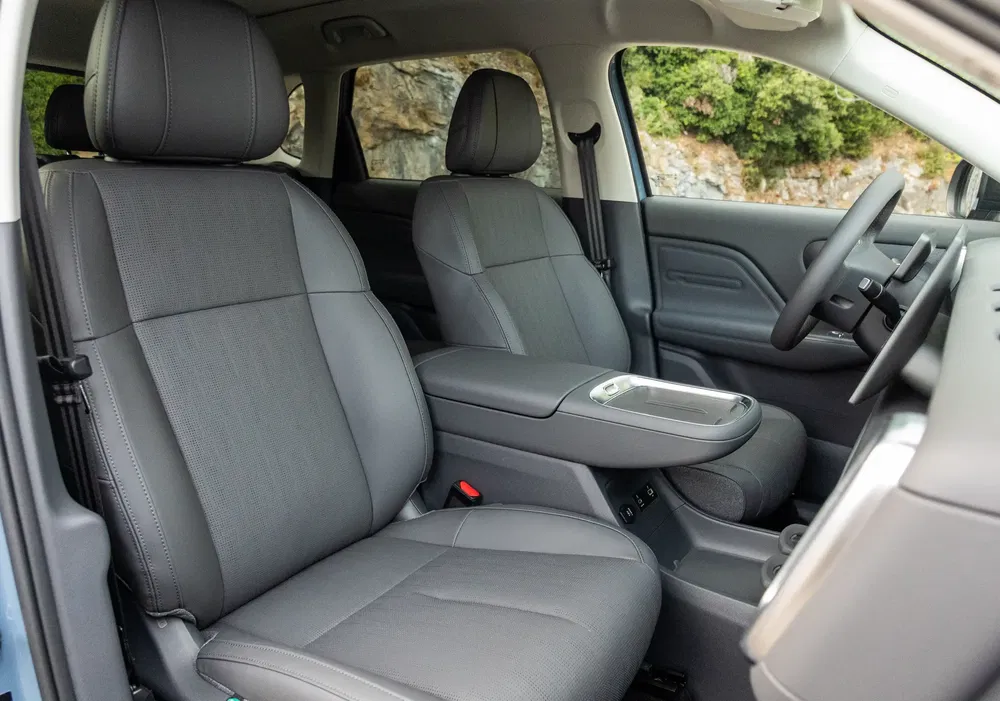 Intérieur d'un SUV moderne avec sièges en cuir gris et console centrale esthétique.