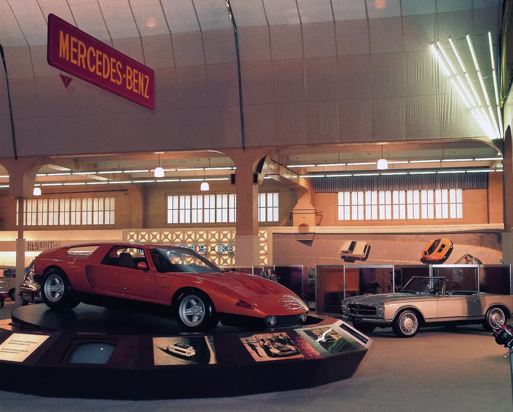 Voitures classiques Mercedes-Benz exposées dans un salon automobile élégant et illuminé.