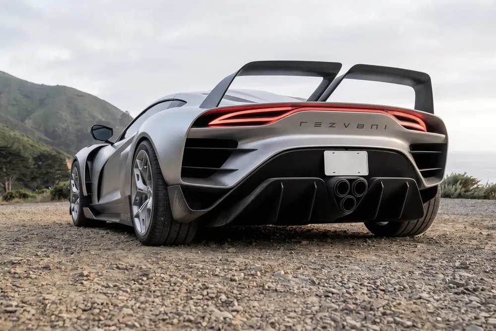 Achteraanzicht van de Rezvani Beast aan zee, indrukwekkend aerodynamisch ontwerp.