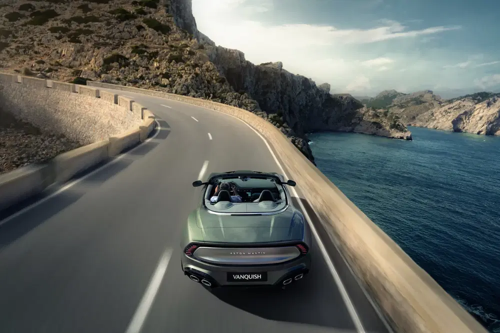 {"fr":"Aston Martin Vanquish décapotable sur une route côtière sinueuse avec vue sur la mer.","nl":"Aston Martin Vanquish cabriolet op kronkelige kustweg met uitzicht op zee."}