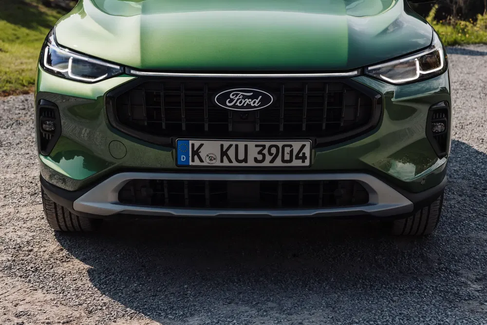 Vue avant d'une Ford verte, plaque d'immatriculation allemande visible.