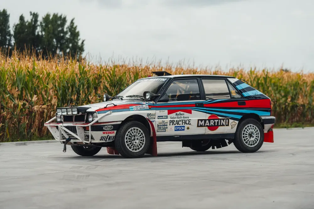 Lancia Delta Integrale rallywagen met Martini-livery, naast een maïsveld.