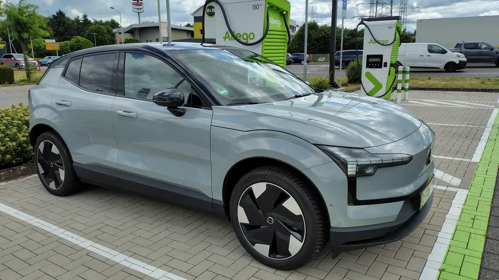 SUV électrique Volvo EX30 à la station de recharge Allego moderne.