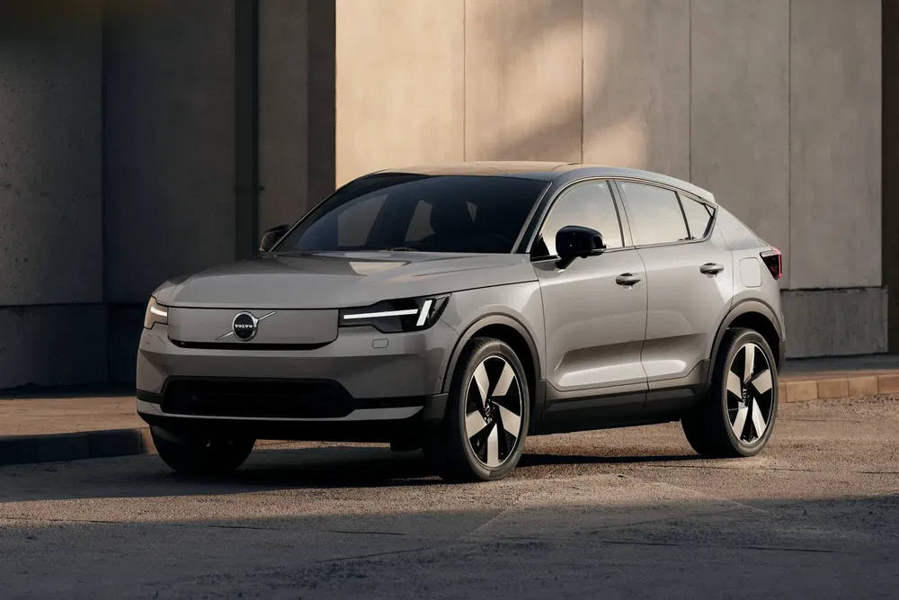 Volvo XC40 gris stationné devant mur, design moderne et élégant.