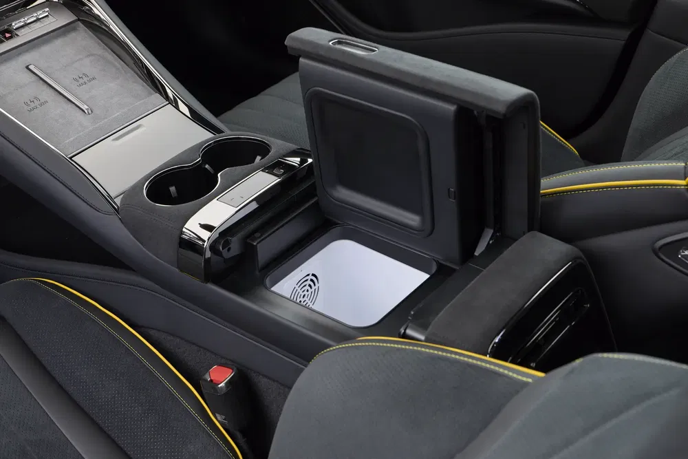 Moderne auto-interieur met bekerhouders en geopende opbergruimte.