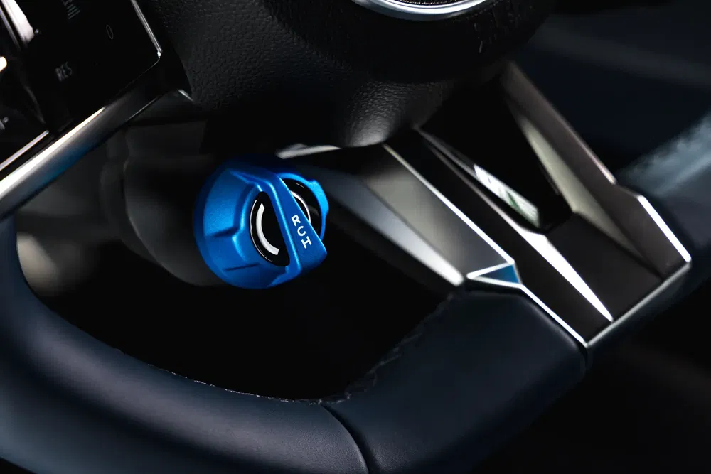 Volant de voiture de sport avec sélecteur de mode bleu, design intérieur moderne et élégant.